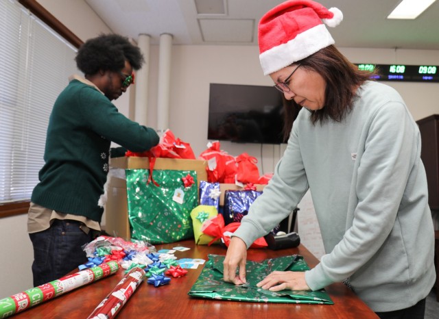 Greg Donald, left, and Harumi Kobayashi, who both work at Logistics Readiness Center-Honshu, wrap gifts before they are donated to a local children&#39;s home in Zama, Japan, Dec. 22, 2023.