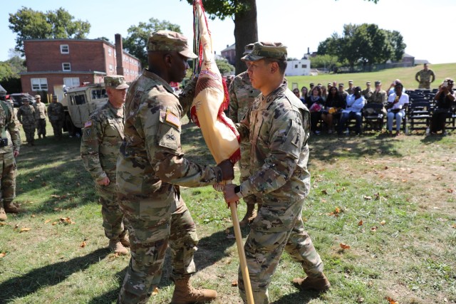 Col. Thomas J. Kim, 77th Sustainment Brigade Commander, presents the colors of the 389th Combat Sustainment Support Battalion to incoming Commander Lt. Col. Terrance Wilson during Change of Command Ceremony at Fort Totten, New York,  September 10,...