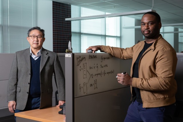 Roy Trieu (left), a computer scientist with the U.S. Army Combat Capabilities Development Command, and Frank Frisby, a data scientist with the U.S. Army Communications-Electronics Command Software Engineering Center, stand at their workspaces at...