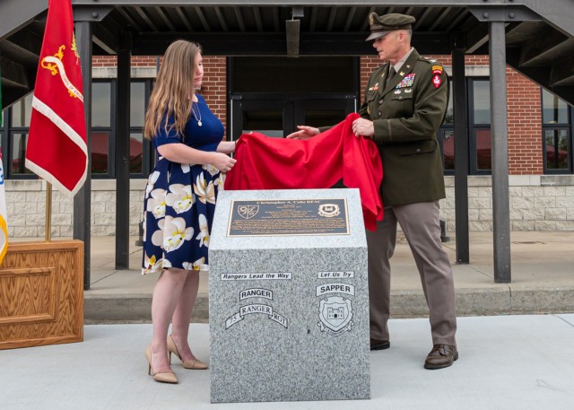 During the Warrior Restaurant dedication ceremony for Bldg. 6111, held Sept. 11, Katie Celiz and Col. Joseph Goetz, U.S. Army Engineer School commandant, unveil a granite monument. The building is renamed for Sgt. 1st Class Christopher Celiz — a combat engineer killed in 2018, while serving in Afghanistan. 