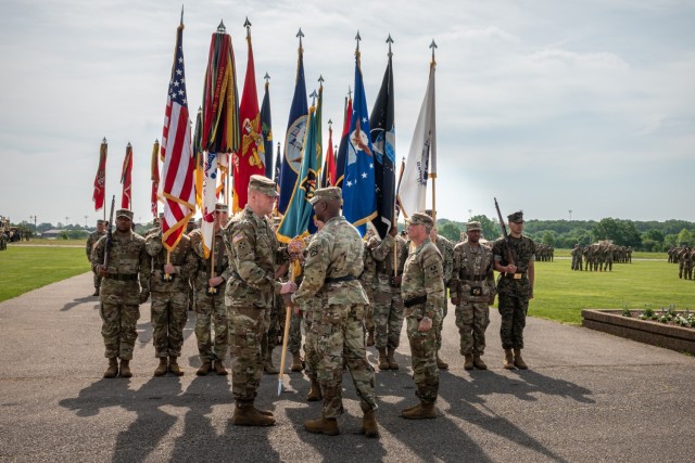 Incoming Maneuver Support Center of Excellence and U.S. Army Fort Leonard Wood Commanding General Maj. Gen. Christopher Beck (left) takes the colors from Lt. Gen. Milford Beagle Jr., U.S. Army Combined Arms Center commanding general, during a ceremony May 19 on Gammon Field. 