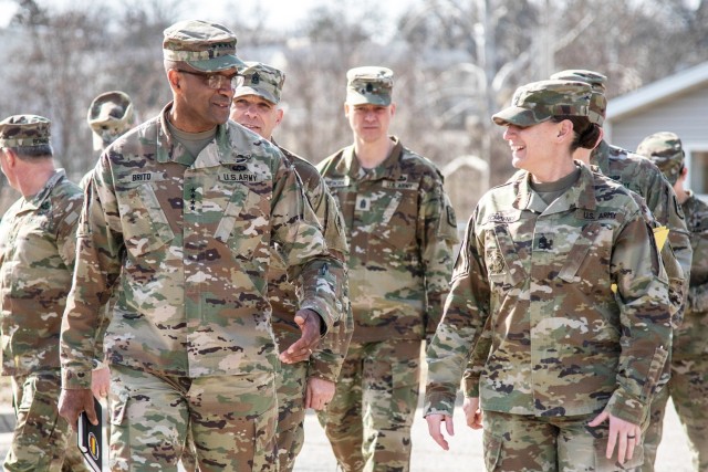 Gen. Gary Brito, commanding general of U.S. Army Training and Doctrine Command, talks with 1st Sgt. Christina Schoener, Basic Military Police Training Division, 14th Military Police Brigade, as they walk through STEM Village viewing military...