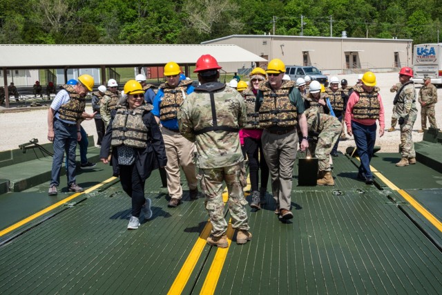 While at Training Area 250 on May 9, the civilian aides to the Secretary of the Army were hands-on with rafting operations as they helped Combat Engineer Skills Division Soldiers build a floating bridge. Once the bridge was completed, the CASAs, as they’re called, boarded the bridge for a ride across the lake.