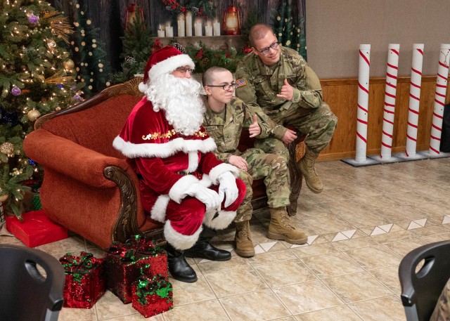Fort Leonard Wood service members pose for a photo with Santa during a Holiday Block Leave event Dec. 21 in Rolla, Missouri, for holdover service members.