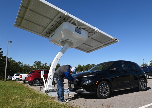 Tommy Morgan, a vehicle dispatcher with the Fort Leonard Wood Transportation Motor Pool, plugs an electric vehicle into one of the installation’s seven new solar charging stations Sept. 25 outside Bldg. 5267. Unlike the other charging stations that have been installed across the installation over the past few months, the solar chargers are government owned and are not tied into the electrical grid. 