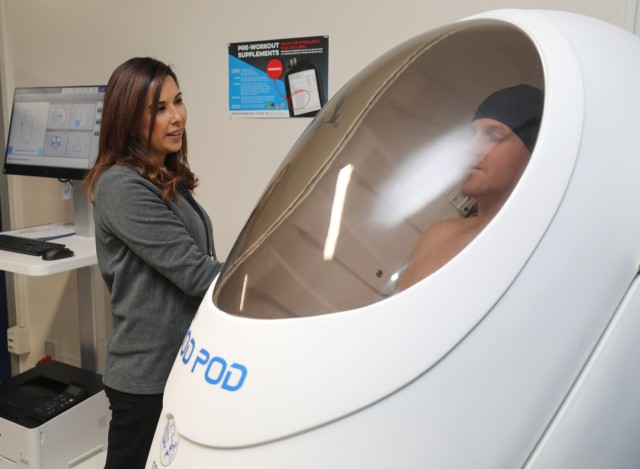 Maria Wallace, left, lead health educator, performs a body composition test using a Bod Pod system on Spc. Jacob Walker inside the Armed Forces Wellness Center at Camp Zama, Japan, Jan. 8, 2024. All participants in the &#34;Biggest Loser&#34; competition will conduct a similar test to track their progress. 