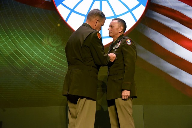 Lt. Gen. Daniel L. Karbler, commanding general, U.S. Army Space and Missile Defense Command, right, receives the Defense Distinguished Service Medal from Gen. James H. Dickinson, commander, U.S. Space