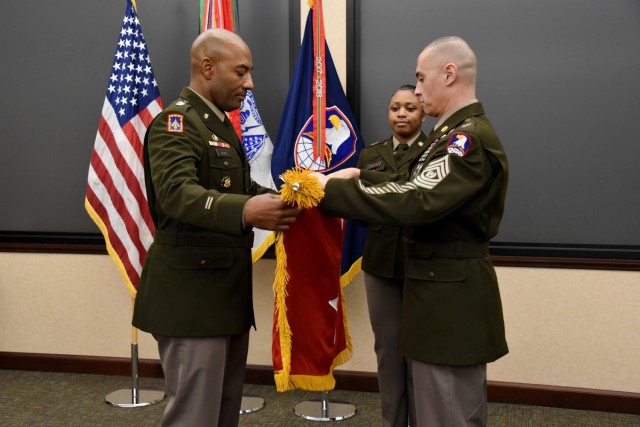 Newly promoted Lt. Gen. Sean A. Gainey, left, unfurls his three-star flag with assistance from Command Sgt. Maj. John Foley, command sergeant major, U.S. Army Space and Missile Defense Command, and St