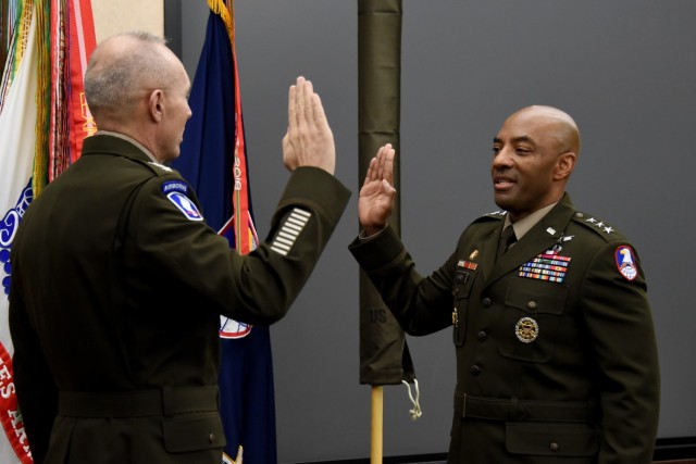 Gen. Randy George, U.S. Army chief of staff, left, administers the oath of office to newly promoted Lt. Gen. Sean A. Gainey during his promotion ceremony at the U.S. Army Space and Missile Defense Com