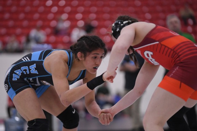 Spc. Estrella Dorado Marin, left, was known for her competitive ferocity on the mat and her devotion to her family, her artistic nature and her infectious giggle off the mat.