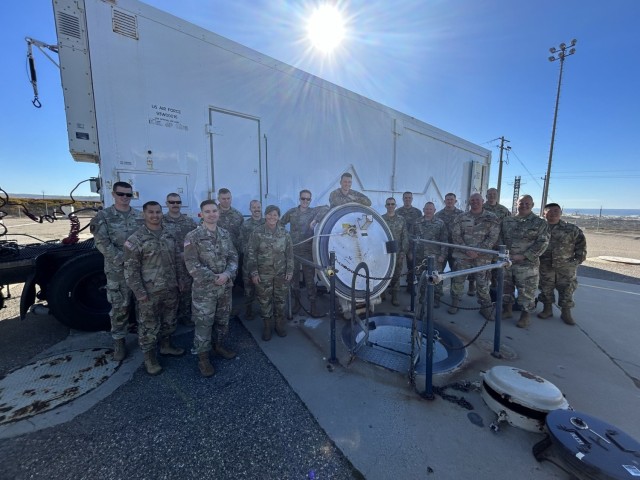 Soldiers of the 100th Missile Defense Brigade pose for a photo at the entrance to an ICBM launch tube on Vandenberg Space Force Base, California.