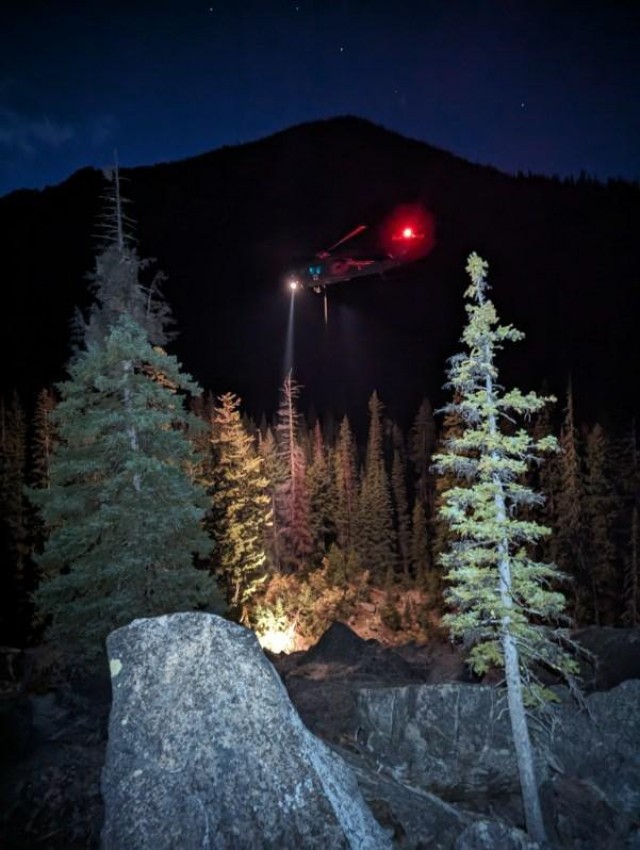A UH-60L Black Hawk assigned to the U.S. Army Air Ambulance Detachment-Yakima, 2-158 Assault Helicopter Battalion, 16th Combat Aviation Brigade, hovers over the Wenatchee National Forest near Leavenworth, Wash. during a rescue mission on Oct 4, 2023. The unit was responding to a request for Federal support from the Chelan County Sheriff's Office to rescue a severely injured hiker. (Photo courtesy of Chelan County Mountain Rescue)