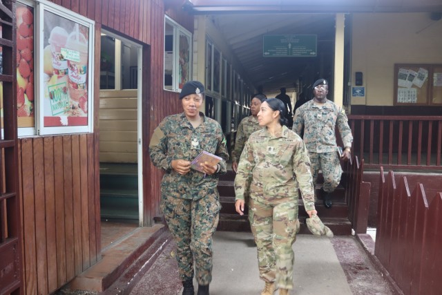 Sgt. Maj. Esmeralda Vaquerano, right foreground, G-1 (personnel) sergeant major for the D.C. Army National Guard, tours the Caribbean Military Academy with a member of the Jamaica Defence Force during a State Partnership Program expert exchange Dec. 12-14, 2023, in Kingston, Jamaica.