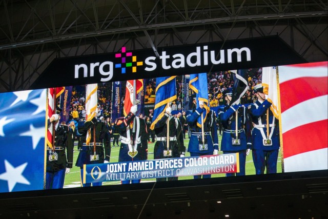 The Joint Armed Forces Color Guard are shown on the jumbotron at NRG Stadium as they present the colors before the 2024 College Football Playoff National Championship Game.