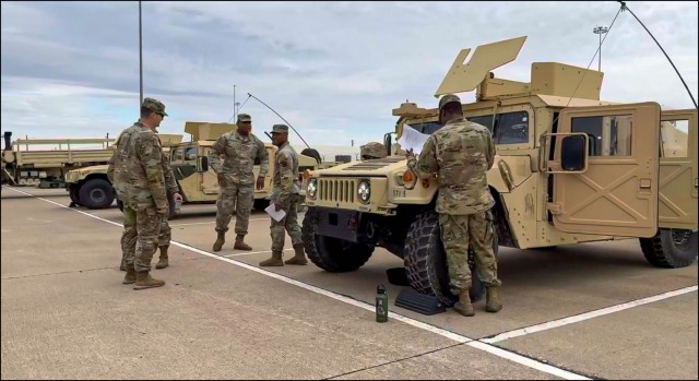 13th Expeditionary Sustainment Command Soldiers inspecting a HMMWV 