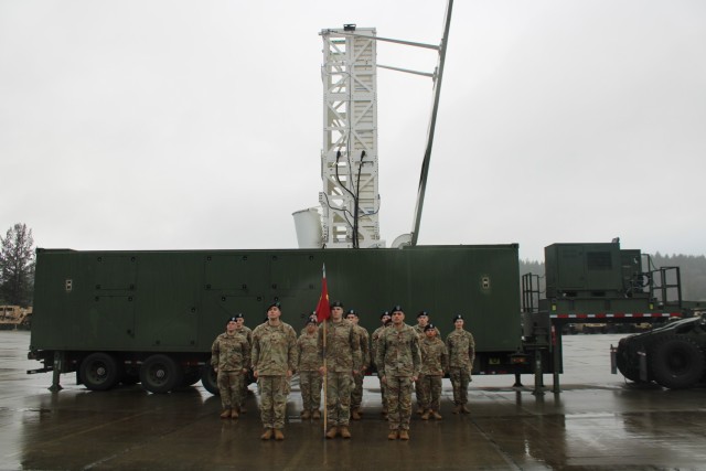 U.S. Army Soldiers from Delta Battery, 5th Battalion, 3rd Field Artillery Regiment, 1st Multi-Domain Task Force stand in formation behind a Mid-Range Capability (MRC) Launcher at Joint Base Lewis-McChord, Washington, January 10, 2024. Delta Battery is the second battery activated as part of the 1st Long-Range Fires Battalion in support of Multi-Domain Operations. The MRC Launcher can fire the Standard Missile - 6 (SM-6) and Tomahawk Land Attack Missile (TLAM).  These missiles allow the Army to prosecute maritime and land targets in support of multi-domain operations. (U.S. Army photo by Caitlyn Davies)