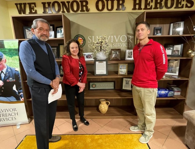 From left to right: Steve Mendiola, Survivor Community Service coordinator; Jolly Miller, USAG-Italy Army Community Service director and Luca Harbeson, community survivor stand beside the Wall of Heroes on Caserma Ederle.