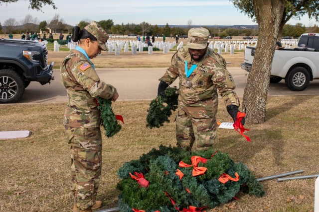 Master Sgt. Bertha Horne, 48th Chemical Brigade, and Sgt. 1st Class Kasim Kennerly, 3rd Armored Brigade Combat Team, 1st Cavalry Division, work to take off the ribbons from the silk wreaths. They both attended the wreath retrieval for the first...