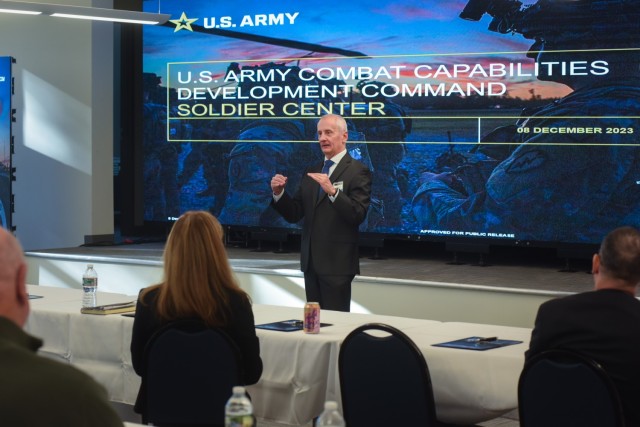 Craig Rettie, Director of Research & Technology Integration at the U.S. Army Combat Capabilities Development Command, or DEVCOM, Soldier Center, addresses the audience during the opening remarks of an afternoon session of the DEVCOM Soldier technologies open house Dec. 8, 2023, at NSSC in Natick, Massachusetts. The open house showcased technologies being developed across DEVCOM to Army senior leaders and Congressional representatives who were in the Boston area for the annual Army-Navy game played at Gillette Stadium in Foxborough. 