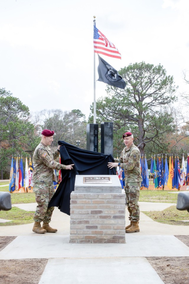 Brig. Gen. David W. Gardner, Joint Readiness Training Center and Fort Johnson commanding general (left), and Post Command Sgt. Maj. David P. Hanson unveil the Sgt. William Henry Johnson memorial Jan. 11.