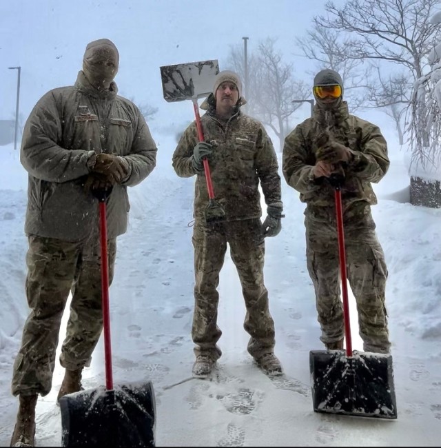 Staff Sgt. Nathan Wojtkowiak, Tech. Sgt. Kevin Pawlukovich and Staff Sgt. Jacob Qualiana, assigned to the 107th Attack Wing, pause from keeping entrances clear at Erie Community South Campus warming station in Orchard Park, New York, Jan. 15, 2024. Seasonally activated warming stations established around Western New York provide stranded and homeless civilians refuge from extreme winter conditions. Air National Guard courtesy photo.