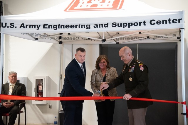 Col. Sebastien Joly, commander of the Engineering and Support Center, Huntsville, cuts the ribbon with the longest serving employee, Jennifer Cooke, an employee since 1987, and the newest employee, Chris Boyett, a project manager who joined the center Jan. 1.
