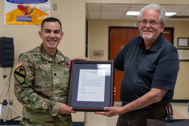Lt. Col. Richard Martinez, commander of the Army Field Support Battalion-Cavazos, poses for a photo with Paul Savage, the principal safety professional with Department of Defense Safety Management Center of Excellence, after presenting Savage a certification of appreciation. (U.S. Army photo by Samantha Harms, Fort Cavazos Public Affairs)