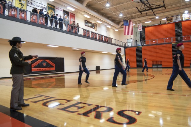 Staff Sgt. Kimberly Villegas, a drill sergeant with Company B, 787th Military Police Battalion, judges an unarmed exhibition performance by Junior ROTC cadets from Ozark High School, in Ozark, Missouri, during the Waynesville Junior ROTC Drill...