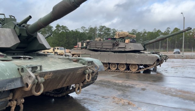 M1A2 Abrams main battle tanks assigned to 1st Armored Brigade Combat Team wait in the bull pen at Fort Stewart&#39;s Red Cloud Range Golf.