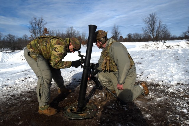 Spc. Emilio Bailey, left, and Spc. Ryan Brust, both indirect fire infantryman with Headquarters and Headquarters Company, 1st Battalion, 125th Infantry Regiment, Michigan Army National Guard, make adjustments to an 81 mm mortar while taking part in exercise Northern Strike 24-1 at Camp Grayling Maneuver Training Center, Michigan, Jan. 21, 2024. Northern Strike 24-1 is the winter warfare component of the annual National Guard Bureau-sponsored Northern Strike exercise series. (U.S. Army photo by Sgt. 1st Class Jon Soucy)