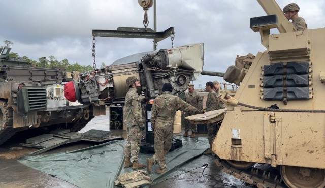 Tank maintainers assigned to 2nd Battalion, 7th Infantry Regiment, 1st Armored Brigade Combat Team, 3rd Infantry Division, pull a power pack from an m1A2 Abrams main battle tank.