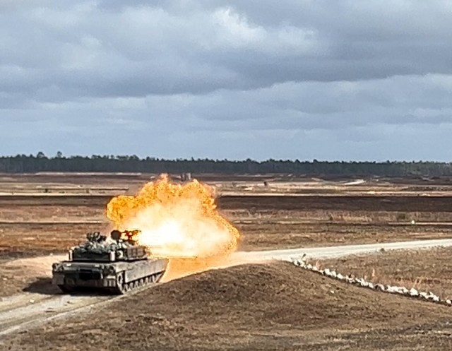 An M1A2 Abrams main battle tank assigned to 1st Armored Brigade Combat Team, 3rd Infantry Division fires a main gun round at a target on Fort Stewart&#39;s Red Cloud Range Golf.