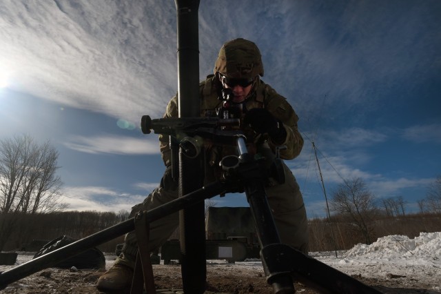 Spc. Emilio Bailey, an indirect fire infantryman with Headquarters and Headquarters Company, 1st Battalion, 125th Infantry Regiment, Michigan Army National Guard, makes adjustments to an 81 mm mortar during exercise Northern Strike 24-1 at Camp Grayling Maneuver Training Center, Michigan, Jan. 21, 2024. Northern Strike 24-1 is the winter warfare component of the annual National Guard Bureau-sponsored Northern Strike exercise series. (U.S. Army photo by Sgt. 1st Class Jon Soucy)