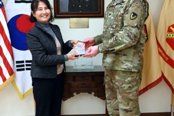CAMP HUMPHREYS, South Korea -- The U.S. Army Garrison Humphreys commander, Col. Ryan Workman, presented a plaque of appreciation to Kim Jeong-ah, direct...