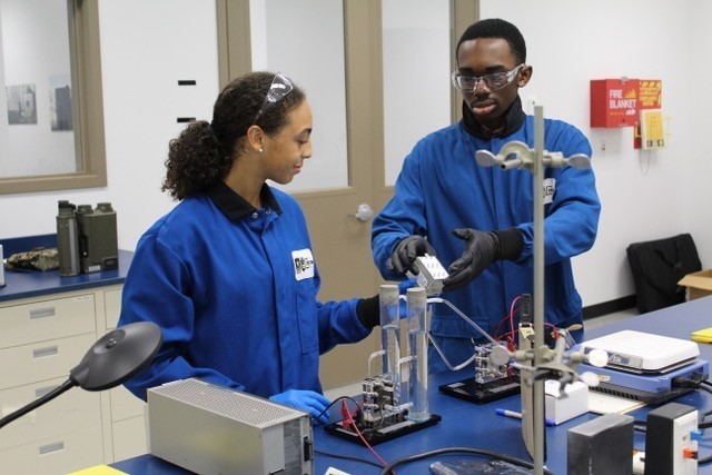 Two U.S. Army Combat Capabilities Development Command, or DEVCOM, Command, Control, Communications, Computers, Cyber, Intelligence, Surveillance and Reconnaissance Center Real-World Internships in Science and Engineering Program students test saline solution July 2023 at Aberdeen Proving Ground, Maryland. 