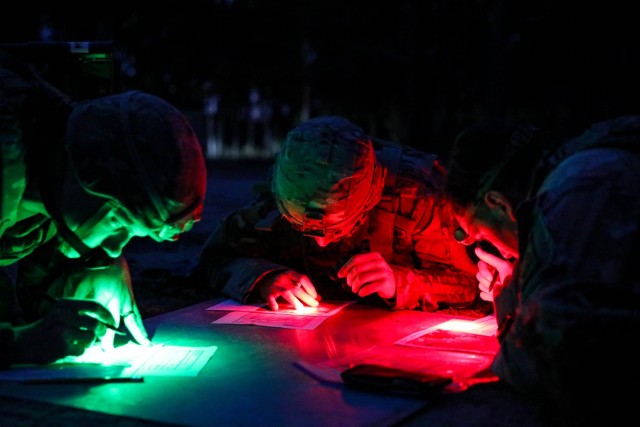 U.S. Army Paratroopers assigned to the 82nd Airborne Division, alongside medics assigned to the 44th Medical Brigade, plan their route at a night land navigation event during the Division’s best medic competition on Fort Liberty, North Carolina, Jan. 18, 2024. The competition, hosted by the 82nd Abn. Div., tested Soldiers' medical knowledge and physical ability as they completed a 13-mile ruck, stress shoot, obstacle course, medical knowledge testing lanes, and a written test. The two highest scoring competitors from each unit are scheduled to move on as a team and represent their respective organizations at the Command Sgt. Maj. Jack Clark Army Best Medic Competition on Fort Liberty in March. (U.S. Army photo by Sgt. Lilliana Magoon)