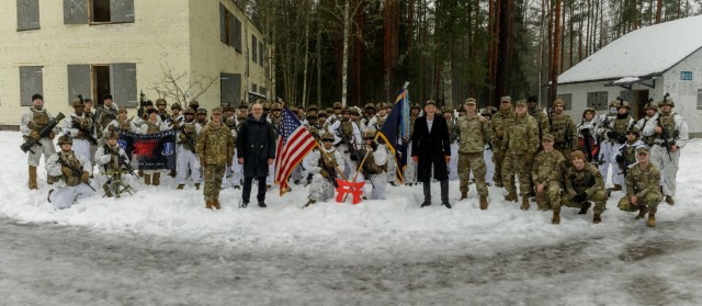 Estonian President Alar Karis and U.S. Ambassador to Estonia George P. Kent join U.S. Army Soldiers with 1st Battalion, 187th Infantry Regiment, "Leader Rakkasans," 3rd Infantry Brigade Combat Team, 101st Airborne Division (Air Assault), supporting 3rd Infantry Division at the conclusion of a military on urban terrain training exercise conducted at the Nursipalu Training Area as part of a tour of Camp Taara, Estonia, Jan. 25, 2024. The 3rd Infantry Division’s mission in Europe is to engage in multinational training and exercises across the continent, working alongside NATO Allies and regional security partners to provide combat-credible forces to V Corps, America’s forward deployed corps in Europe. (U.S. Army photo by Staff Sgt. Oscar Gollaz)
