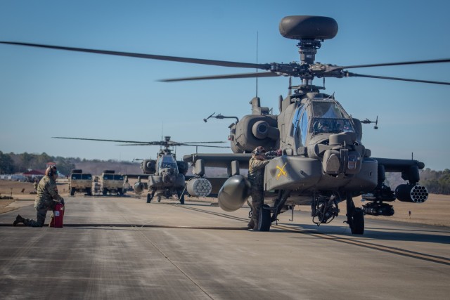 Soldiers from 96th Aviation Support Battalion, 101st Combat Aviation Brigade, 101st Airborne Division (Air Assault) refuel AH-64 apache helicopters at Oxford, MS, during a Large-Scale, Long-Range Air Assault (LLAASLT) into the Joint Readiness...