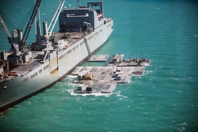 Army mariners assigned to the 368th Seaport Operations Company and 331st Transportation Company construct a causeway adjacent to the Merchant Vessel Maj. Bernard F. Fisher off the coast of Bowen, Australia, July 29, 2023.