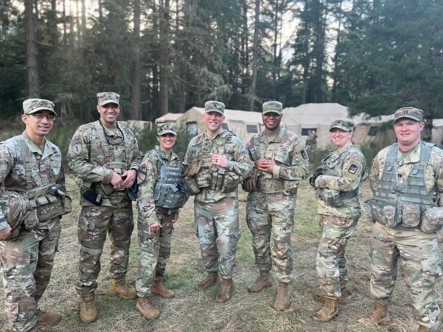 Lt. Col. Patrick Miller poses for a photo with the senior staff  of his battalion at Joint Base Lewis-McChord, Washington in 2022. Miller never thought about leaving the Army during his recovery.