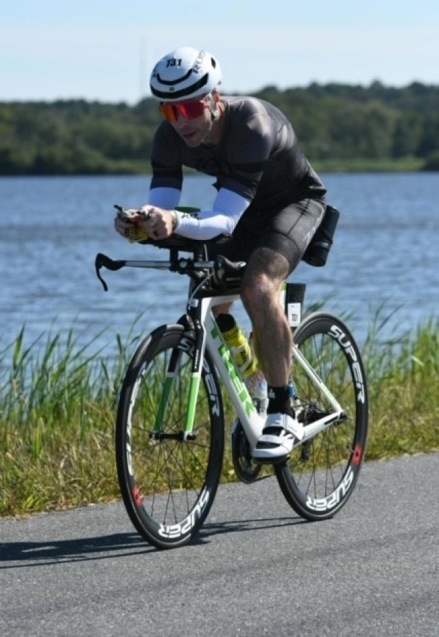 Lt. Col. John Dexter on his bike during the Ironman competition. The cycling portion of the race is 112 miles of track immediately following the 2.4-mile swim.