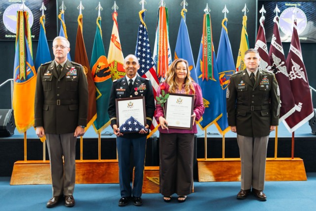 Chief Warrant Officer 5 Immanuel Delacruz stands with his spouse Rhojon Delacruz at the Fort Novosel retirement ceremony at the Army Aviation Museum on Feb. 2, 2024.