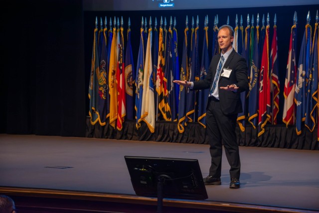 Dr. Keith Brawner stands on the stage of Eisenhower Auditorium to give a keynote address during the 2024 Directors of Training Conference at the Lewis and Clark Center on Fort Leavenworth, Kan.
