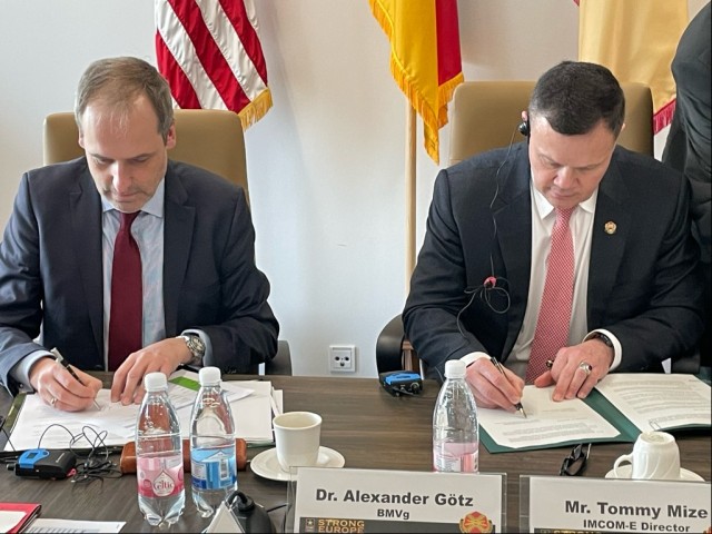 Dr. Alexander Götz, with the German Ministry of Defense, left, and Tommy Mize, IMCOM-Europe Director, sign an agreement to increase the threshold for Army construction projects in Germany. The agreement between IMCOM-Europe and the German Ministries of Defense and Construction will streamline and improve the process for military construction in Germany. 
