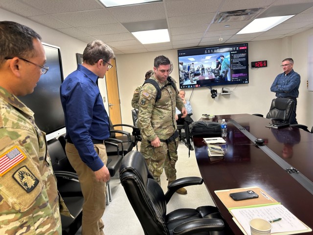 U.S. Army Soldier, Capt. Ryan Scott, demonstrates a exoskeleton technology while Chad Hearing, a technical project manager from DEVCOM, discussed his team&#39;s current endeavors, including a biomechanical and ergonomic analysis of medical tasks...
