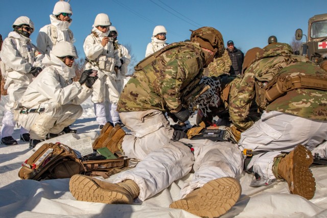 U.S. Paratroopers from HHC, 1st Battalion, 501st Parachute Regiment, 2nd Infantry Brigade, 11th Airborne Division give a demonstration on U.S. Army Tactical Combat Casualty Care to Japanese Ground Self-Defense Force (JGSDF) members with HHC, 28th...