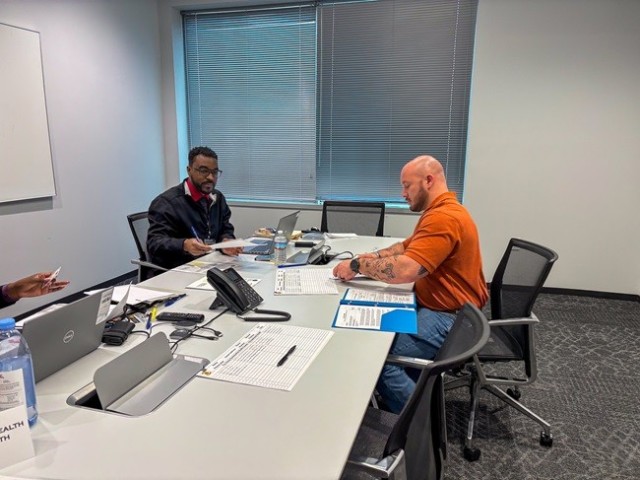 Dave Wilson, of the Directorate of Human Resources, Army Substance Abuse Program, talks with job applicant Isaac Fatzinger during the Garrison’s public hiring event. 