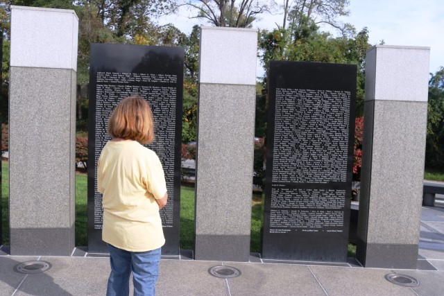 A visitor reflects at the Maryland World War II Memorial.