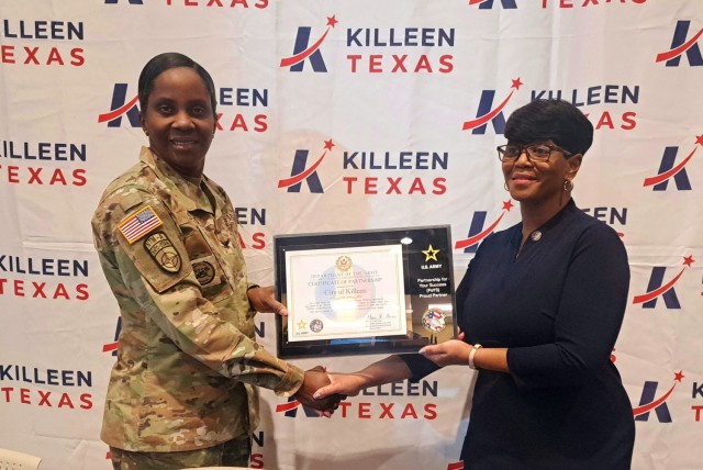 Col. Lakicia Stokes, U.S. Army Garrison-Fort Cavazos commander, and Debbie Nash-King, city of Killeen mayor, pose holding a commemorative plaque after signing a partnership agreement for the Army&#39;s Partnership for Your Success program Jan. 30, 2024, at Killeen City Hall. (U.S. Army photo by Janecze Wright, Fort Cavazos Public Affairs)