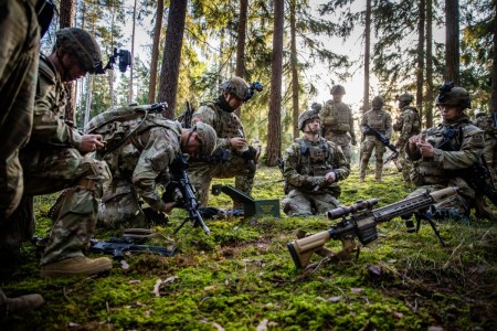 U.S. Soldiers, assigned to the 2nd Squadron, 2nd Cavalry Regiment prepare weapons for training during a simulated training exercise at Vilseck, Germany Feb. 5, 2024. The exercise engages in platoon-level training within field and urban environments, enhancing their combat readiness and team cohesion.